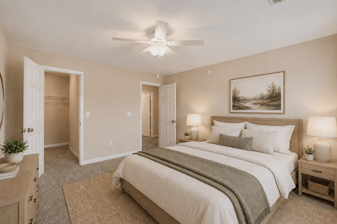 A bedroom with a large bed and a painting on the wall.