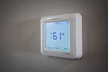 a white thermostat sitting on top of a white wall at Beacon Hill and Great Oaks Apartments, Rockford, IL, 61109
