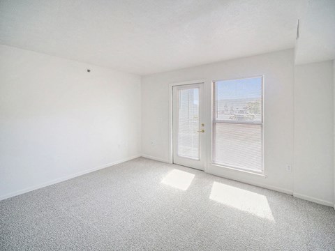 the living room with a door to a patio at Black Sand Apartment Homes in Lincoln, NE