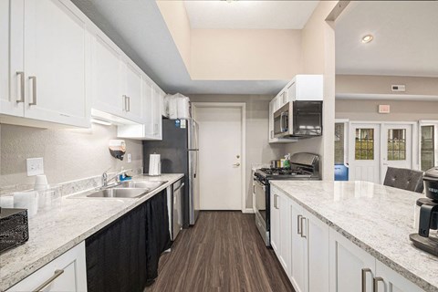 a clubhouse kitchen with white cabinets at Black Sand Apartment Homes, Nebraska