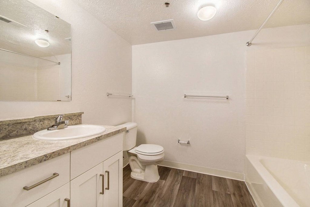 A bathroom with a sink, toilet, and bathtub at Brentwood Park Apartments, La Vista, Nebraska