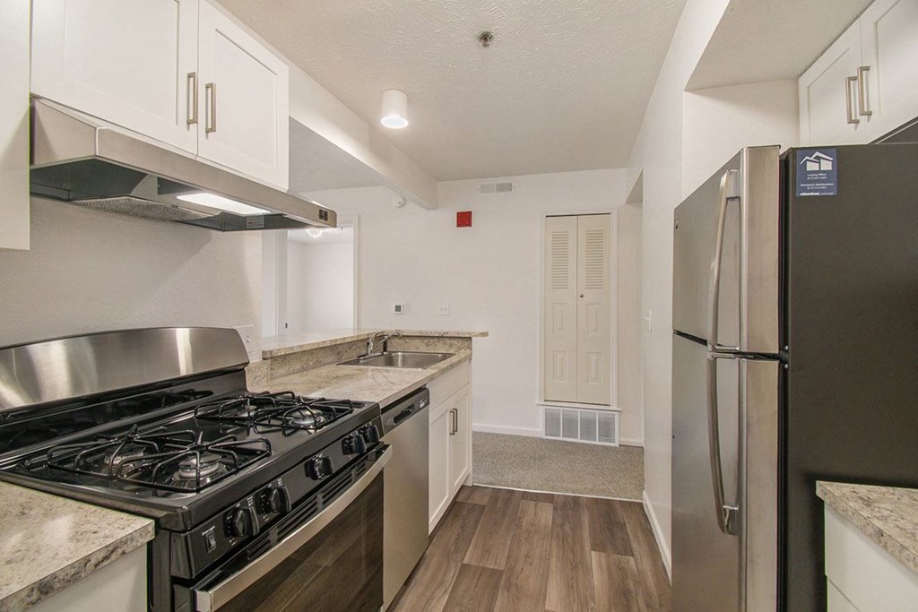 A kitchen with stainless steel appliances and white cabinets at Brentwood Park Apartments, La Vista, Nebraska