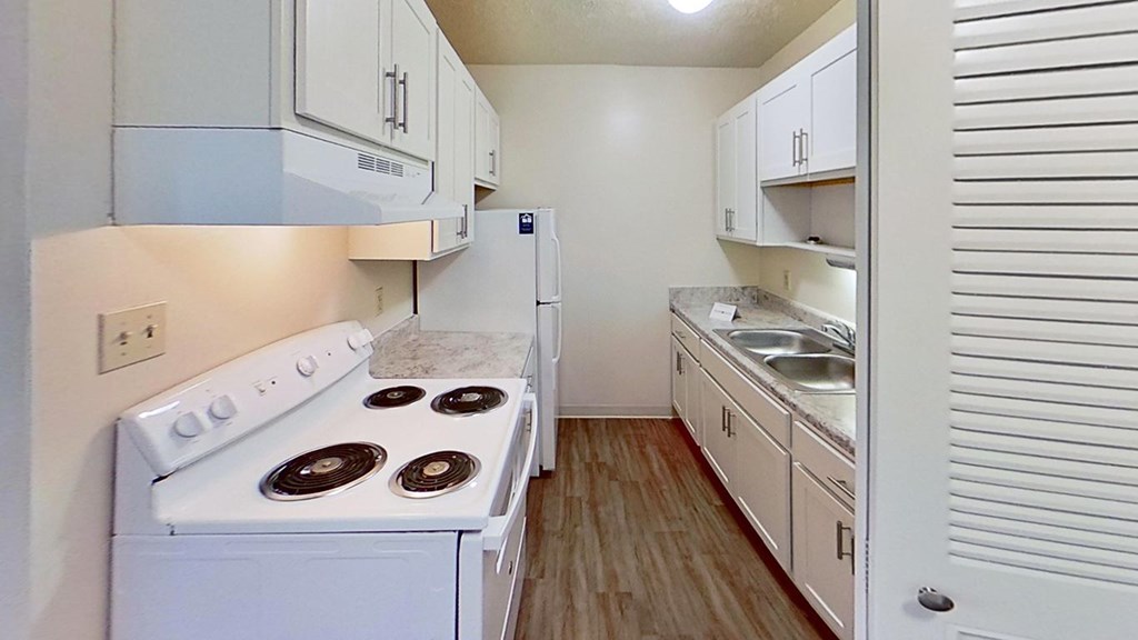 An upgraded kitchen with white cabinets at Briarwood Apartments in Benton Harbor, MI