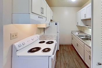 a kitchen with a sink and a refrigerator at Briarwood Apartments, Benton Harbor, 49022