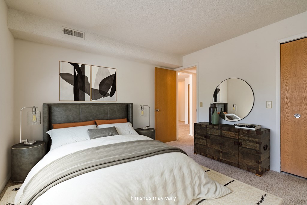 a bedroom with a large bed and a dresser with a mirror at Brook Pines, Columbia, SC, 29210