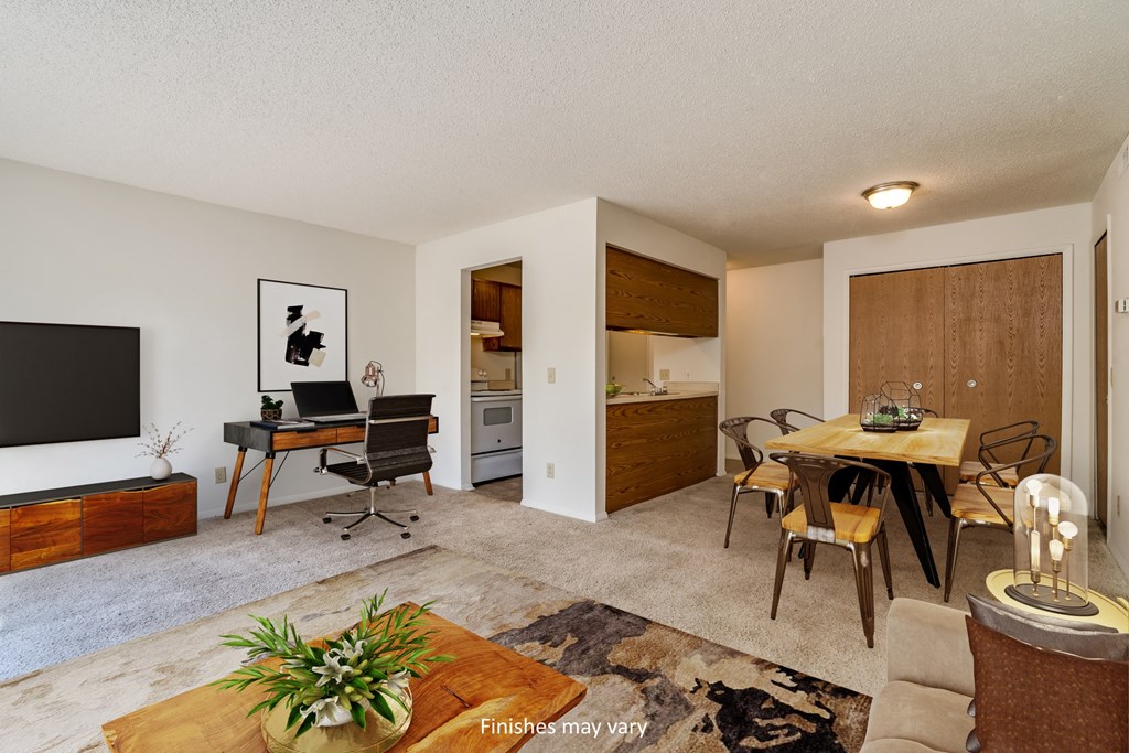 a living room and dining area with a desk and chairs and a flat screen tv  at Brook Pines, Columbia, SC