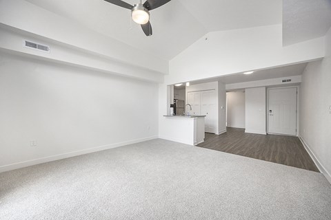 Empty living room with open kitchen layout at Byron Lakes Apartments, Michigan