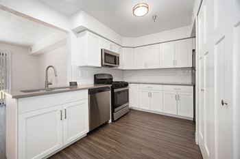 Kitchen with Breakfast Bar at Byron Lakes Apartments in Byron Center, MI