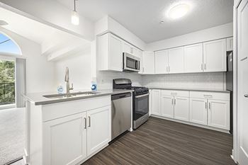 Kitchen with Breakfast Bar at Byron Lakes Apartments in Byron Center, MI