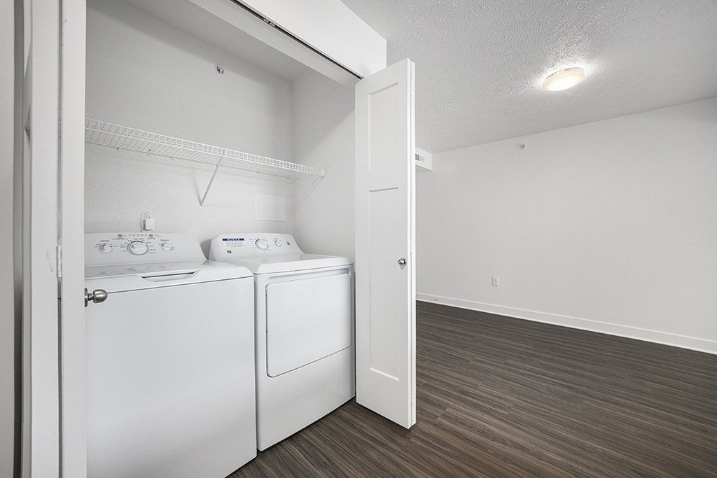 A white washer and dryer in a closet at Byron Lakes Apartments, Byron Center, MI