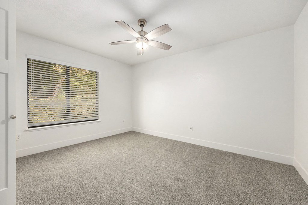 bedroom with a large window at Byron Lakes Apartments, Byron Center, Michigan