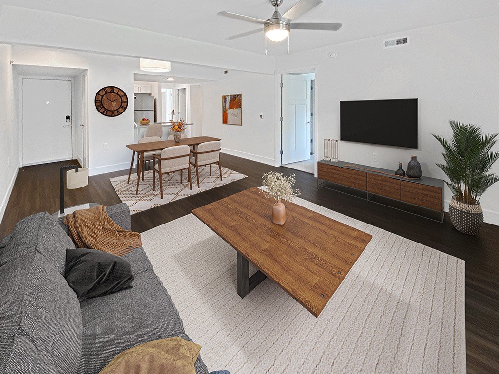 a living room with a ceiling fan and hard surface flooring at Byron Lakes Apartments in Byron Center, MI