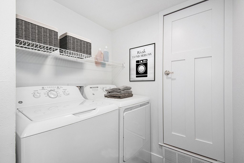 A laundry room with a washer and dryer at Byron Lakes Apartments in Byron Center, MI