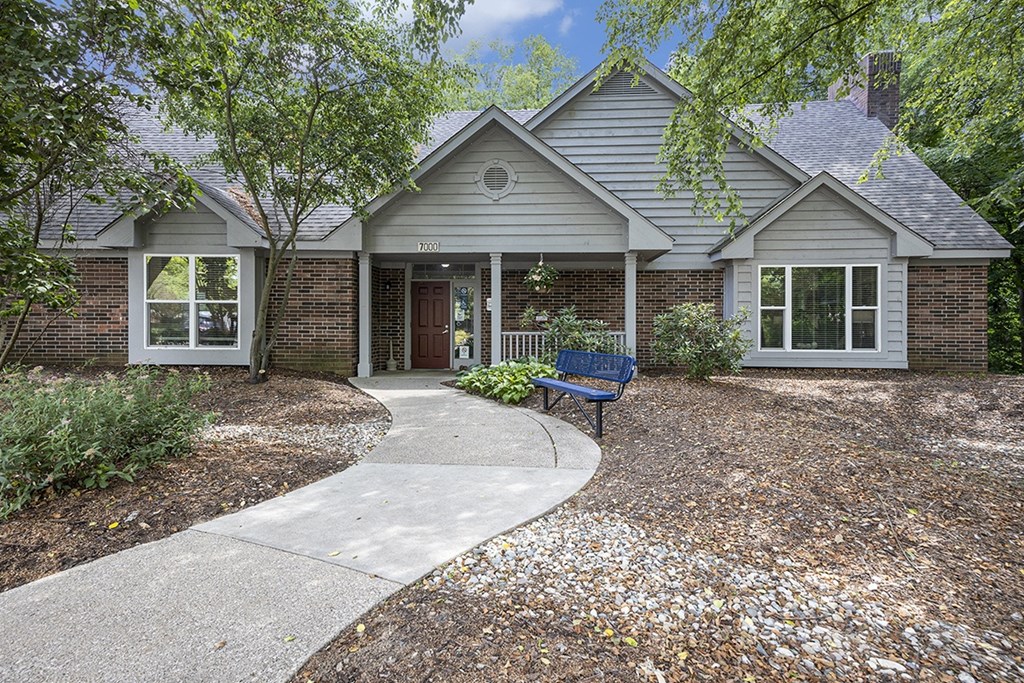 A leasing office and community building with landscaping in front at Byron Lakes Apartments, Byron Center, MI