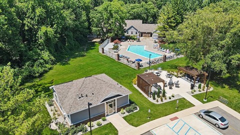 A house with a pool and a carport.