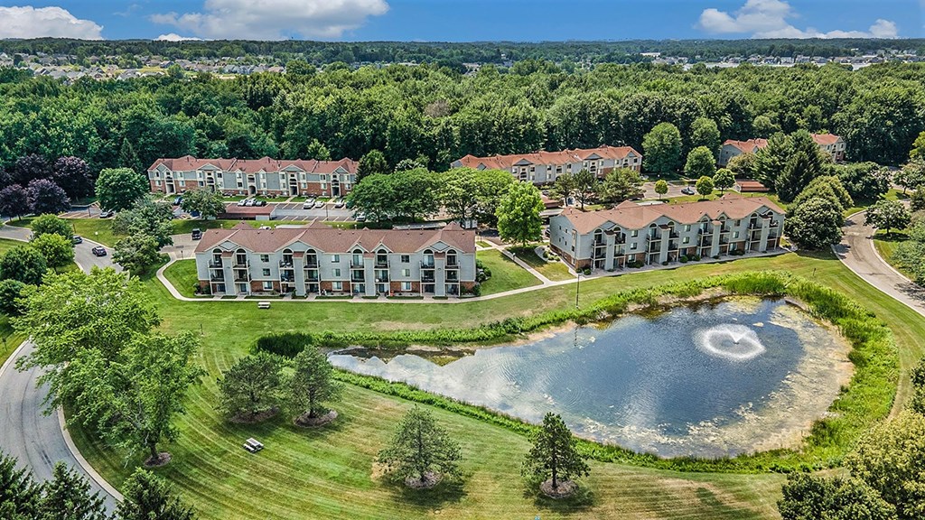 A drone overhead view of a beautiful community with ponds at Byron Lakes Apartments, Byron Center, MI