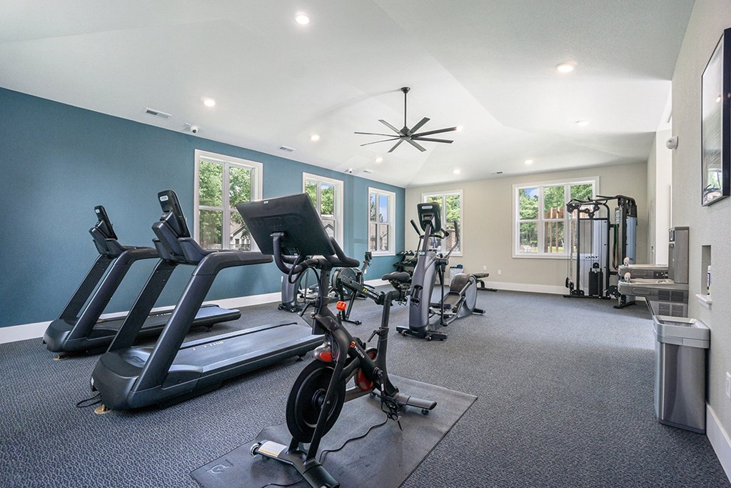 A fitness center with treadmills, exercise bike, and other equipment at Byron Lakes Apartments in Byron Center, MI