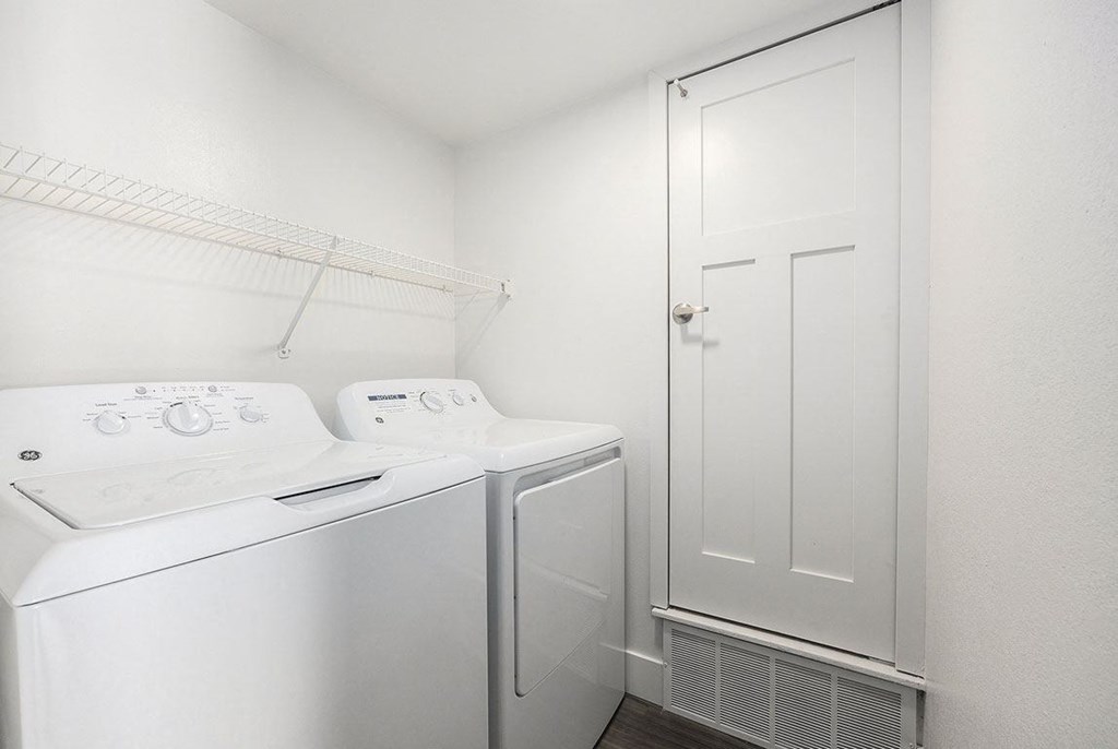 a laundry room with a full size washer and dryer at Byron Lakes Apartments, Byron Center, MI