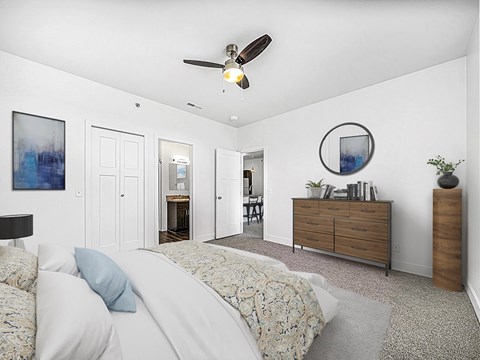 A bedroom with a bed, dresser, and ceiling fan at Chase Creek Apartment Homes, Huntsville, AL, 35811