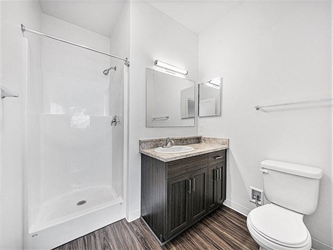 a bathroom with a toilet, sink and shower at Chase Creek Apartment Homes, Huntsville