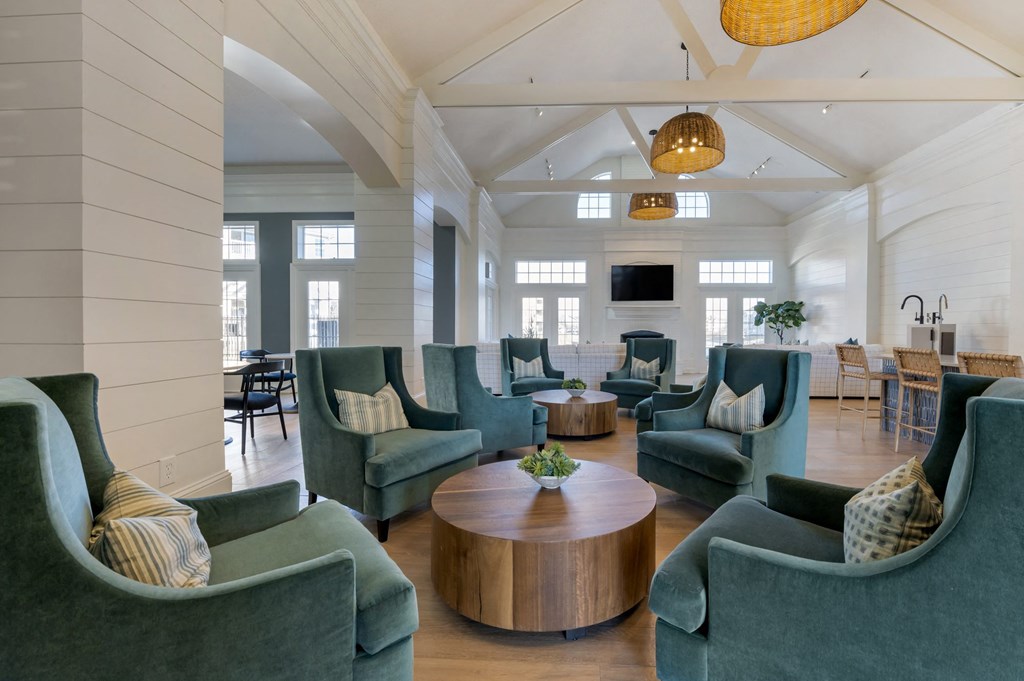 a living room filled with furniture and a large window at Latitudes Apartments, Indianapolis