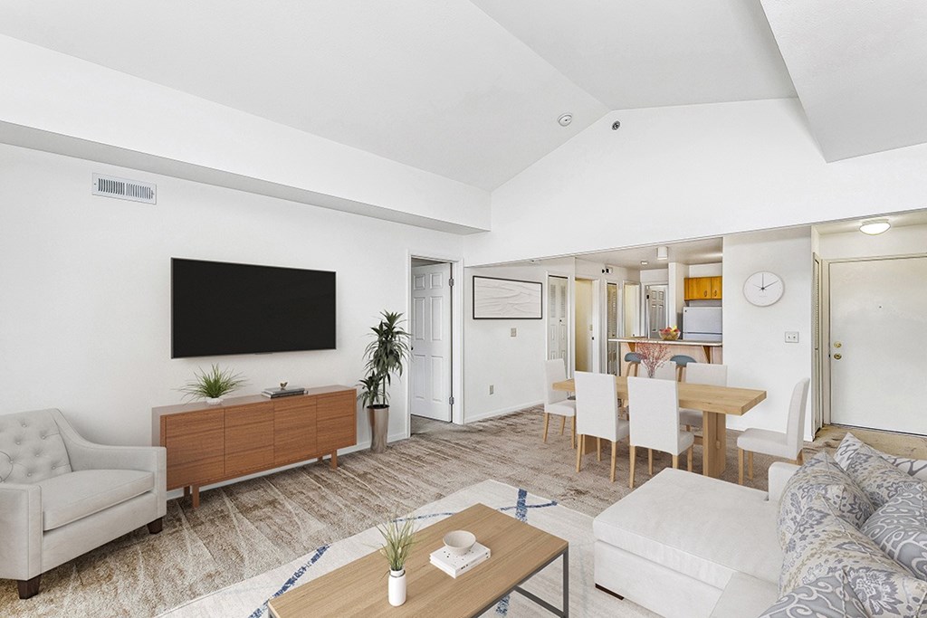 A living  and dining room with a flat screen TV mounted on the wall at Colonial Pointe at Fairview Apartments, Bellevue, Nebraska