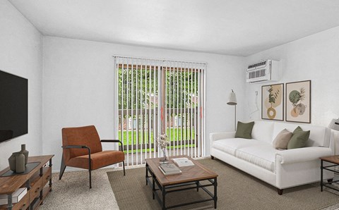 A living room with a white couch, a brown chair, and a coffee table.