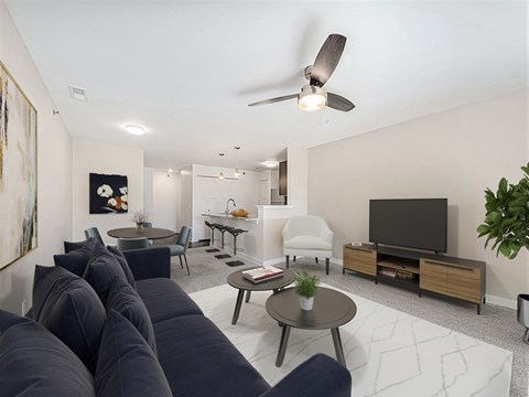 A living room with a dark blue sofa and a television.