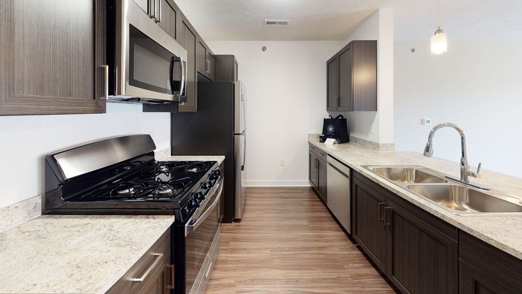 A two bedroom kitchen with stainless steel appliances at Copper Creek Apartment Homes, Maize