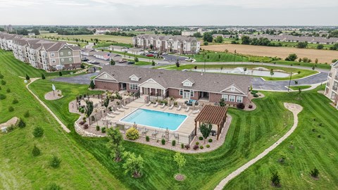 Aerial view of clubhouse pool and surrounding green space at Copper Creek Homes Apartments, Maize, KS