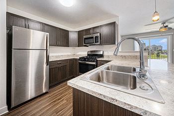 Kitchen with Stainless Steel Appliances at Copper Creek Apartment Homes in Maize, Kansas