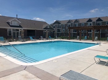Sparkling Pool Beside Community Building Sparkling Pool beside Community Building at Copper Creek Apartment Homes in Maize, Kansas - Photo Gallery 4