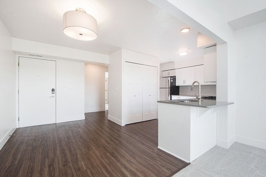 A kitchen with white cabinets and a hard-surface floor at The Crossings Apartments, Grand Rapids, MI, 49508