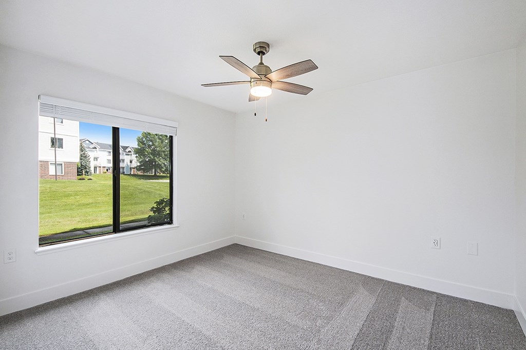 Spacious bedroom with large window at The Crossings Apartments, Grand Rapids, Michigan