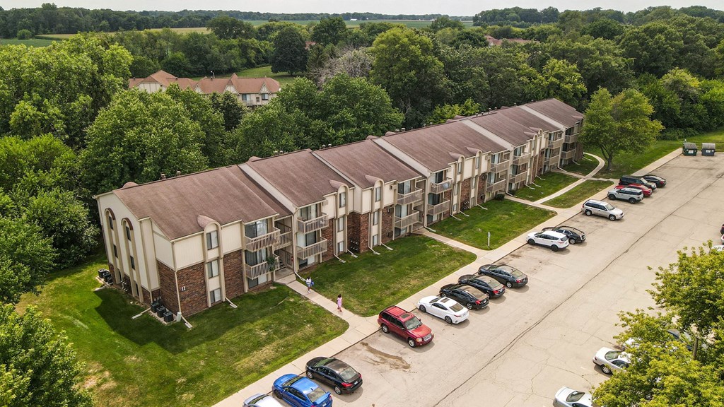 an aerial view of an apartment complex with cars parked in front at Beacon Hill and Great Oaks Apartments, Illinois