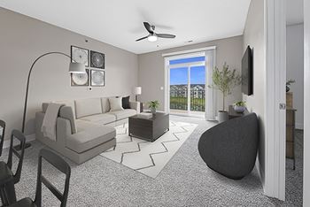 A living room with a 9' ceiling and a ceiling fan at Dodson Pointe Apartment Homes in Rogers, AR