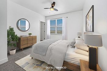 A bedroom with a ceiling fan at Dodson Pointe Apartment Homes, Rogers, AR