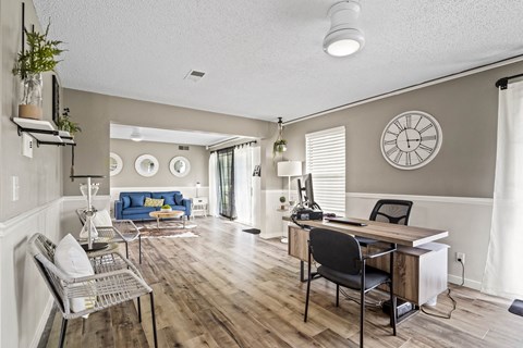 the living room and dining room of a house with a table and chairs