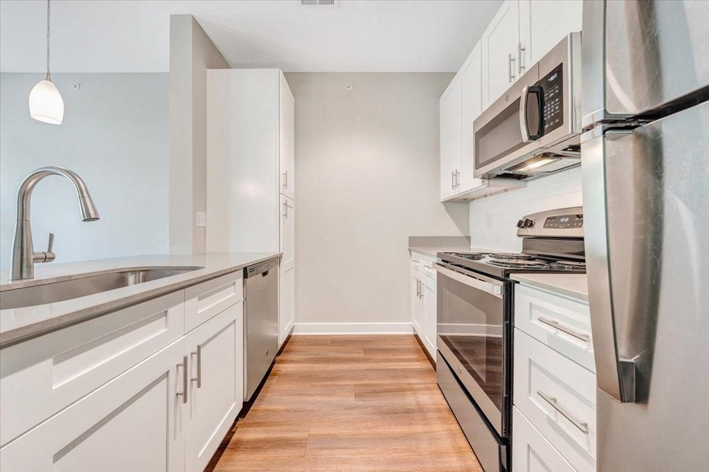 a kitchen with stainless steel appliances and white cabinets