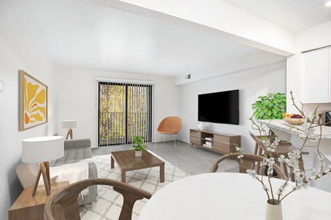 A living room with a white sofa, and a wooden coffee table leading to a balcony at Emerald Park Apartments, Michigan, 49001