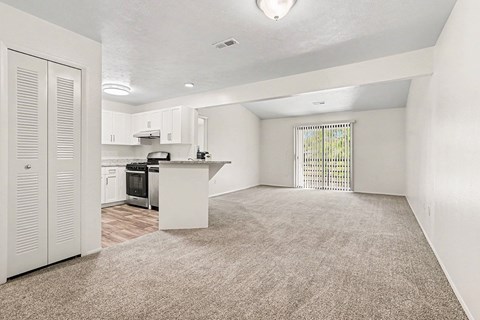 A kitchen with white cabinets and a white island with a window.
