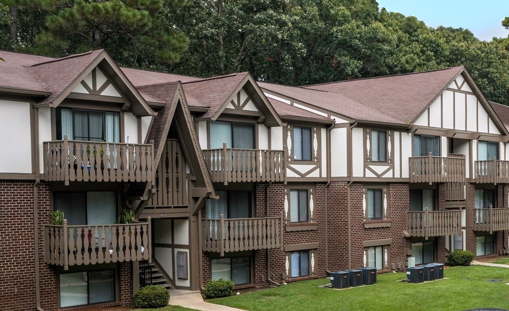 Apartment building with brown brick and white walls.
