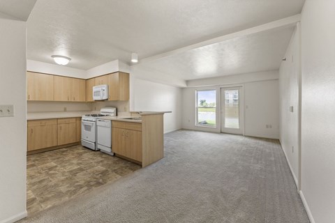 A kitchen with wooden cabinets and a white dishwasher.