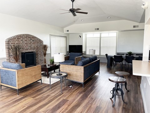 A living room with a brick fireplace and a couch.