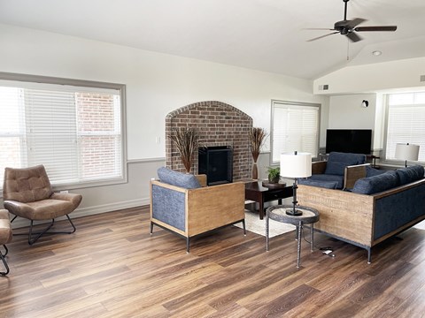 A living room with a brick fireplace and a couch.