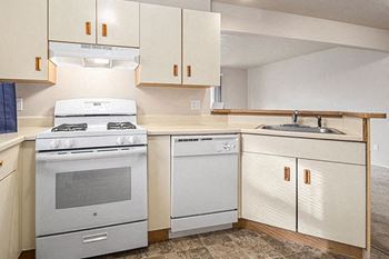 A kitchen with a gas stove and a dishwasher at Foxwood and The Hermitage, Portage