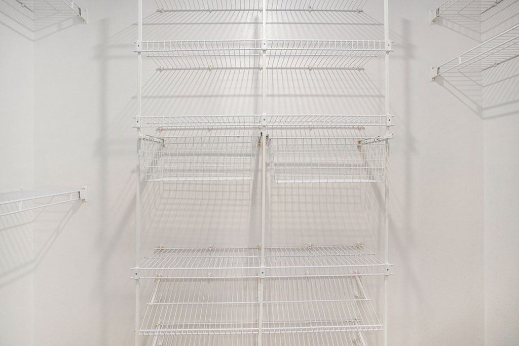 a walk in closet with wardrobe organizers at Glenn Valley Apartments in Battle Creek, MI