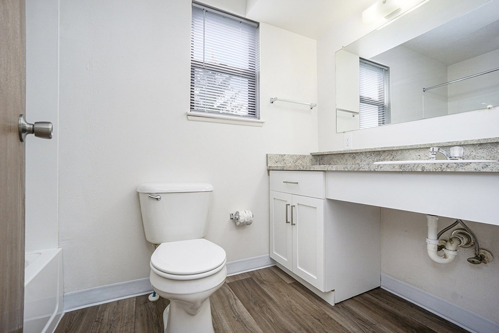 An upgraded bathroom with a window and hard-surface floor at Glenn Valley Apartments, Battle Creek, MI, 49015