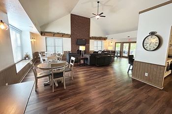 A community building with a hard-surface floor and a brick fireplace wall at Glenn Valley Apartments in Battle Creek, MI