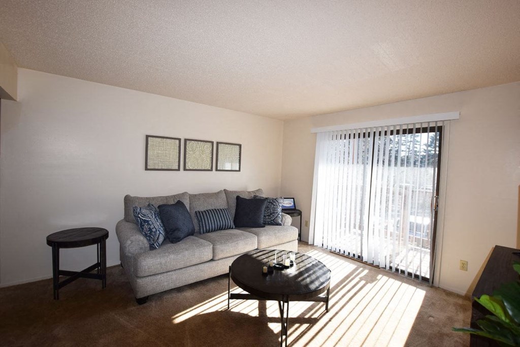 Living Room With Sliding Glass Door To Balcony at Granada Apartments, Jackson, Michigan